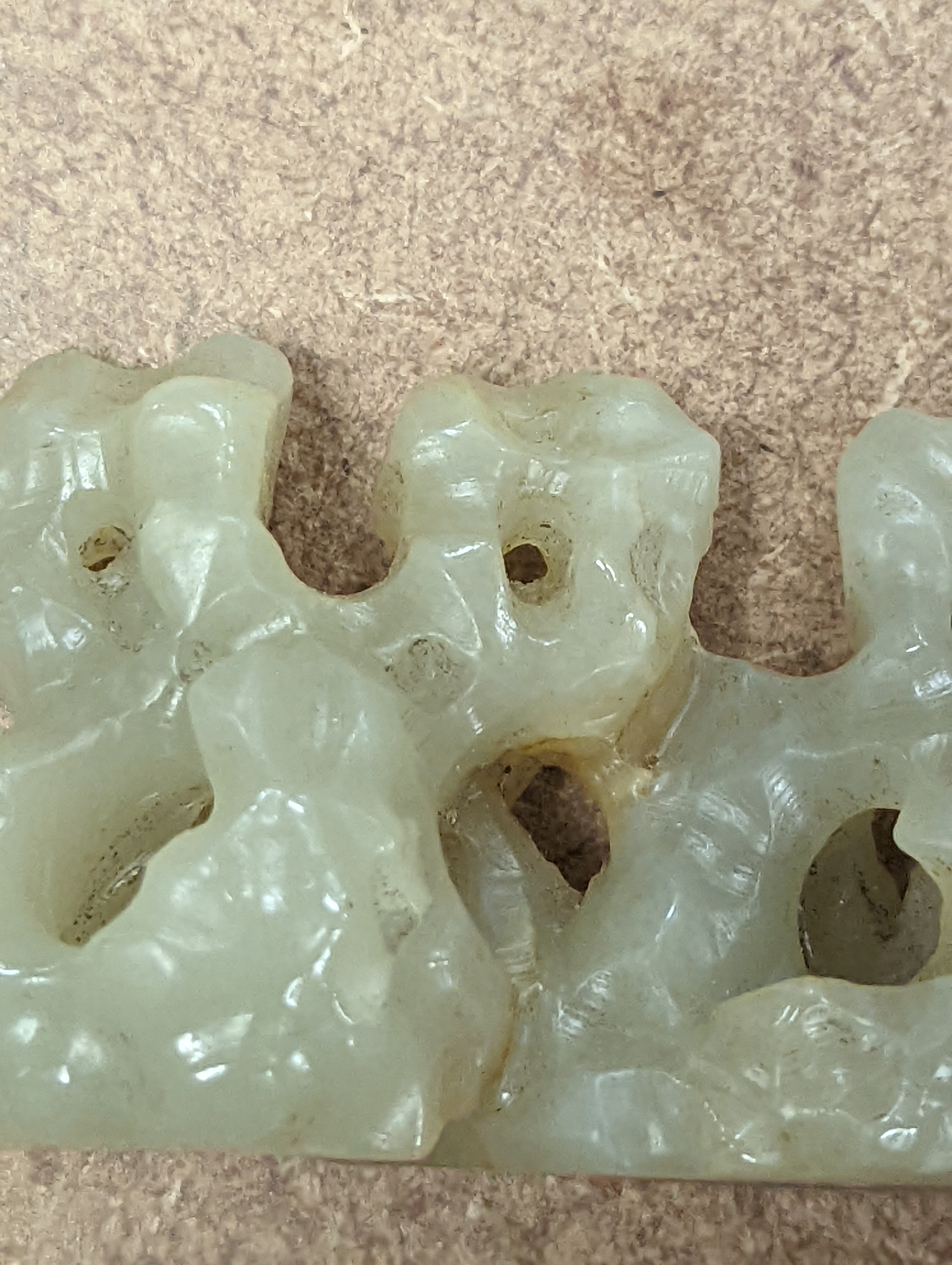 A Chinese celadon jade brush rest, 8cms wide